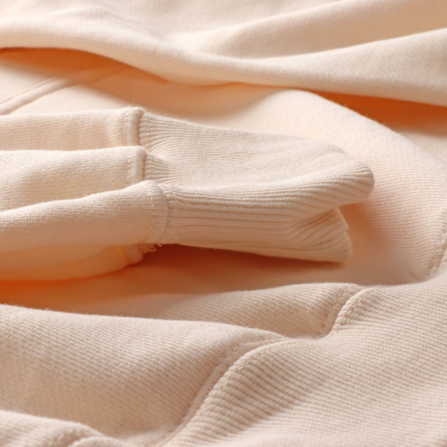 Taylors Evermore Hoodie - Close up of beige embroidered eras album detail