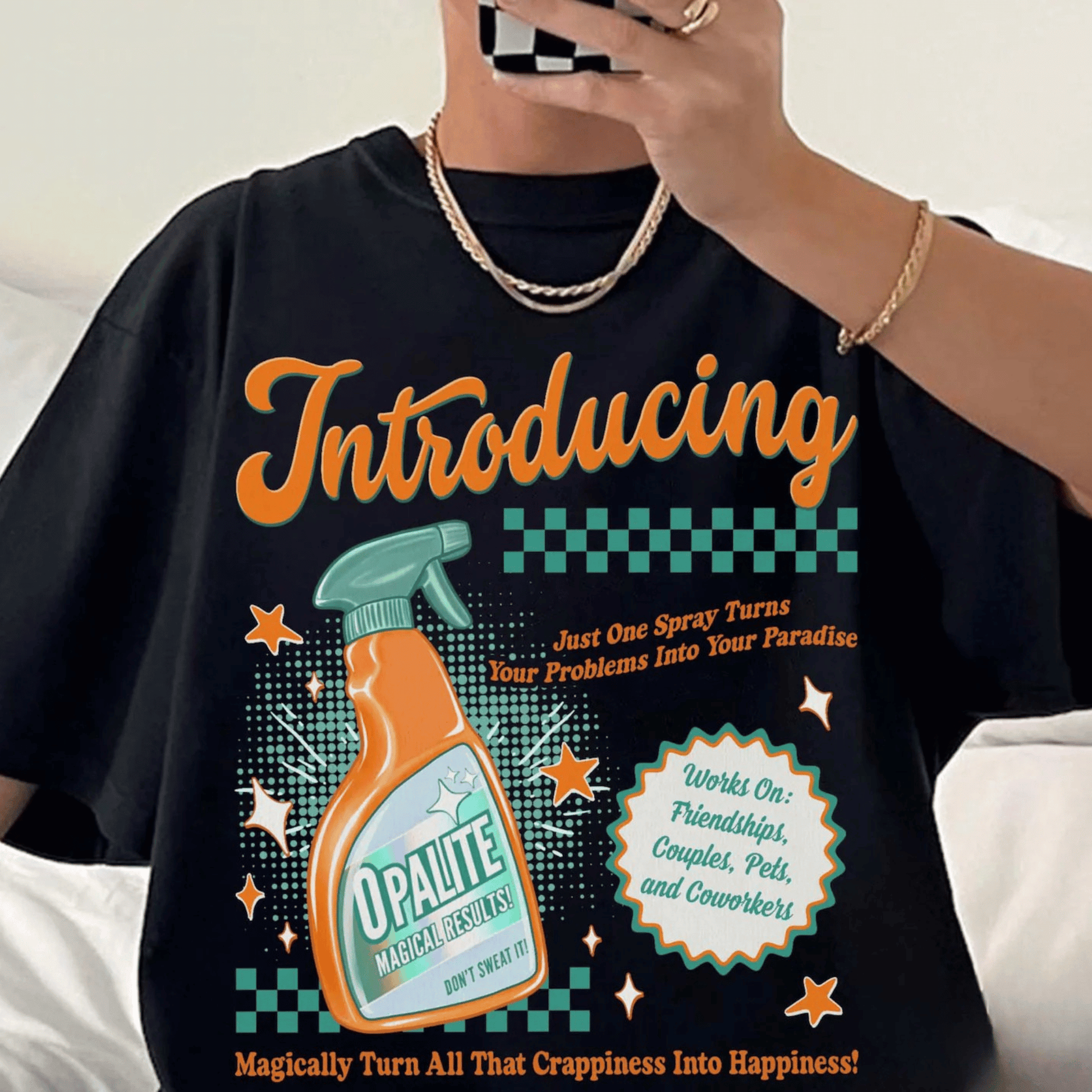 Black t-shirt with colorful graphic and text, featuring a spray bottle and text about 'Opalite'.
