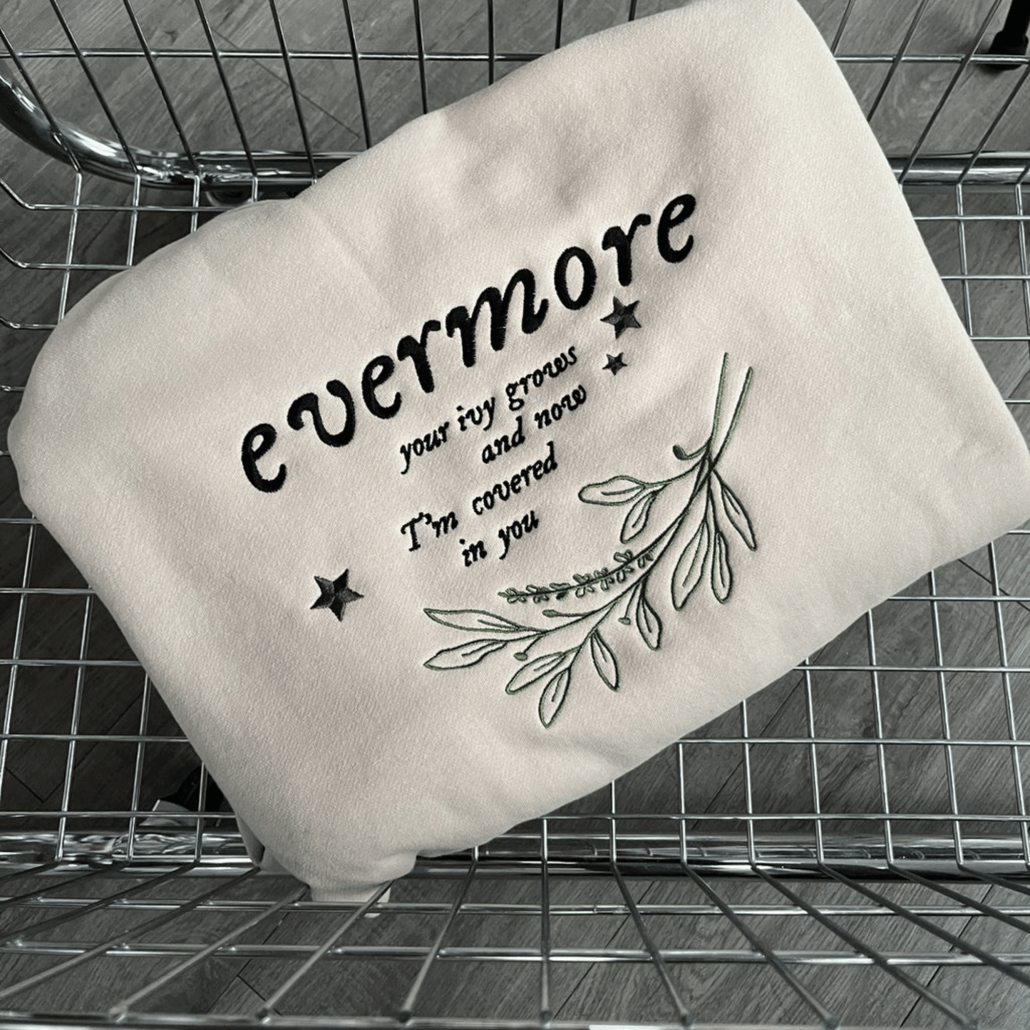 White pillow with text and star design on a metal surface