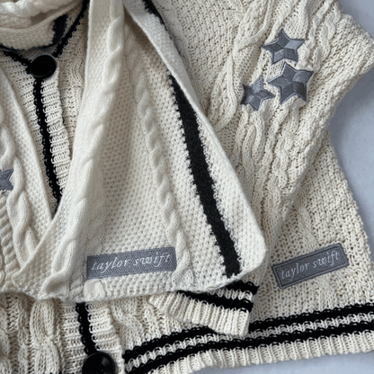 Knitted sweater with star patterns and 'Taylor Swift' labels on a light background
