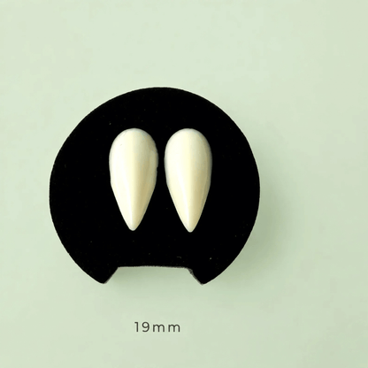 A pair of off-white pointed teardrop-shaped nail tips displayed on a black backing card against a pale mint green background, with '19 mm' text printed below.