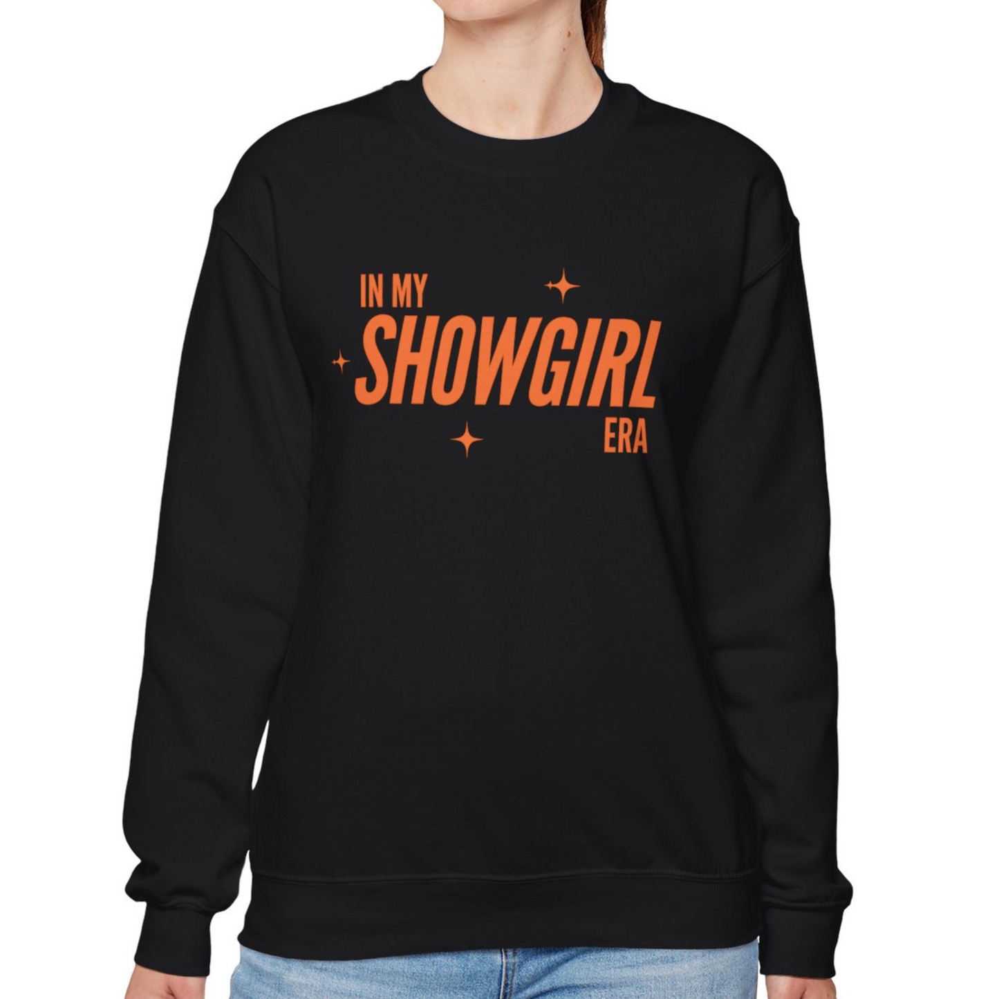 Black sweatshirt with orange text 'IN MY SHOWGIRL ERA' on a white background