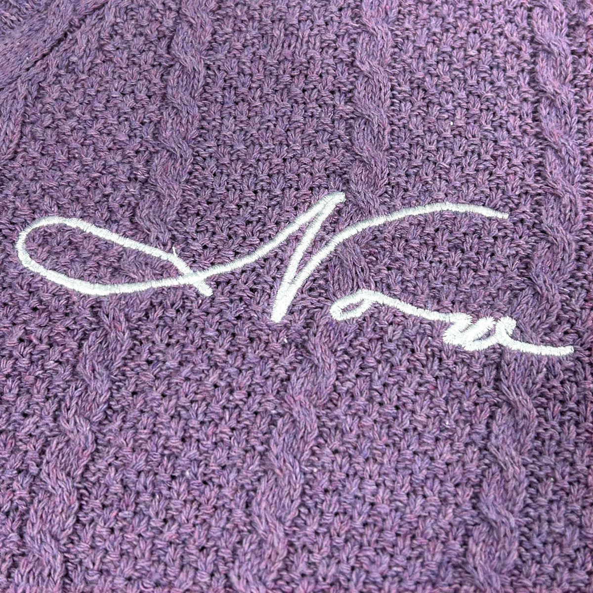 Purple crop cardigan flat lay showing full front embroidery and structure