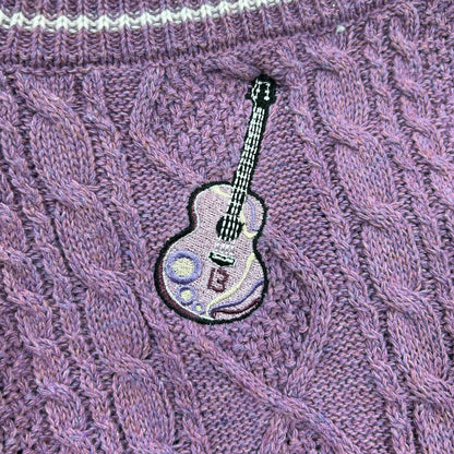 Purple crop cardigan showing three tonal star accents at elbow on sleeve