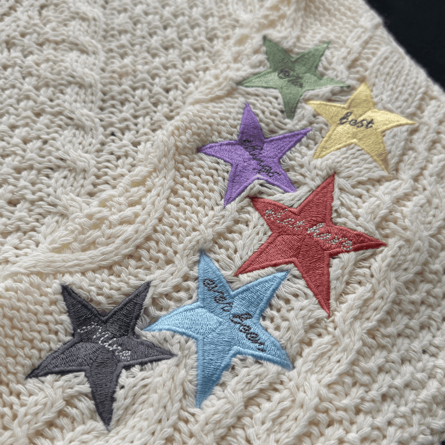Colorful star-shaped patches on a textured fabric background