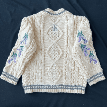 Knitted sweater with floral patterns on a dark background