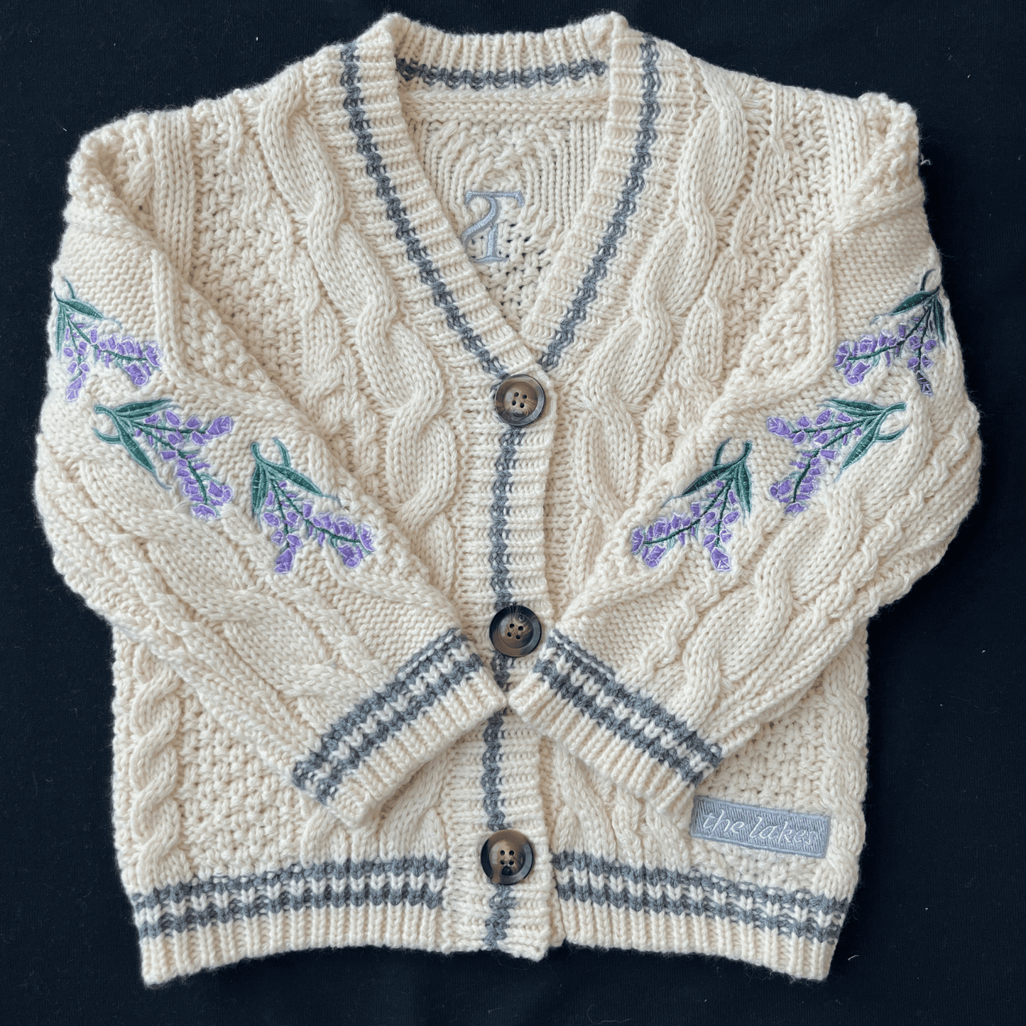 Knitted cardigan with floral patterns on a black background