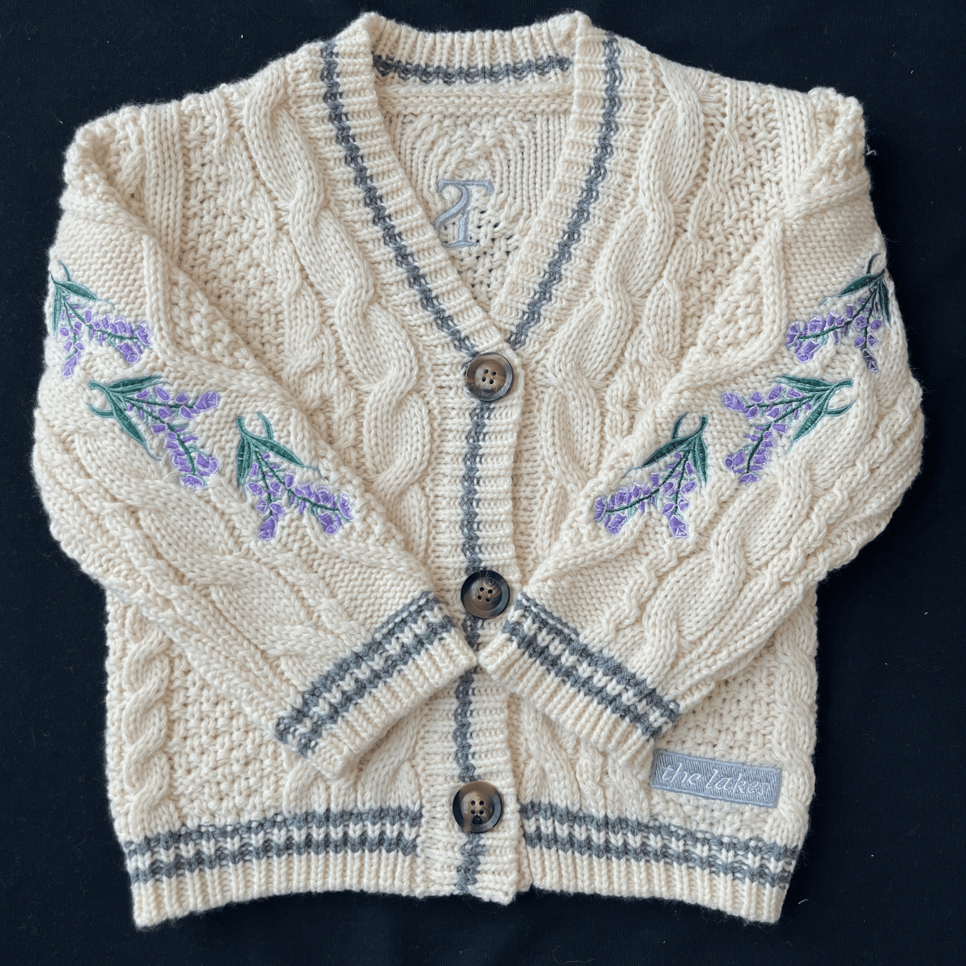 Knitted cardigan with floral patterns on a black background