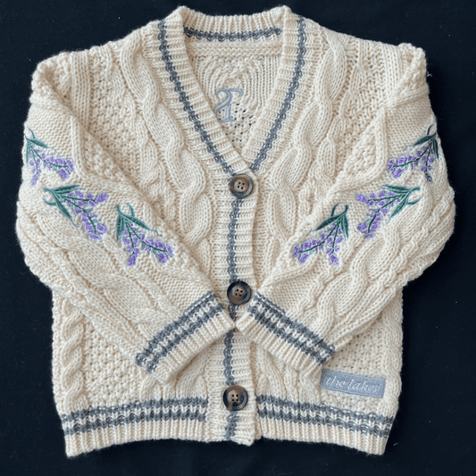 Knitted cardigan with floral patterns on a black background