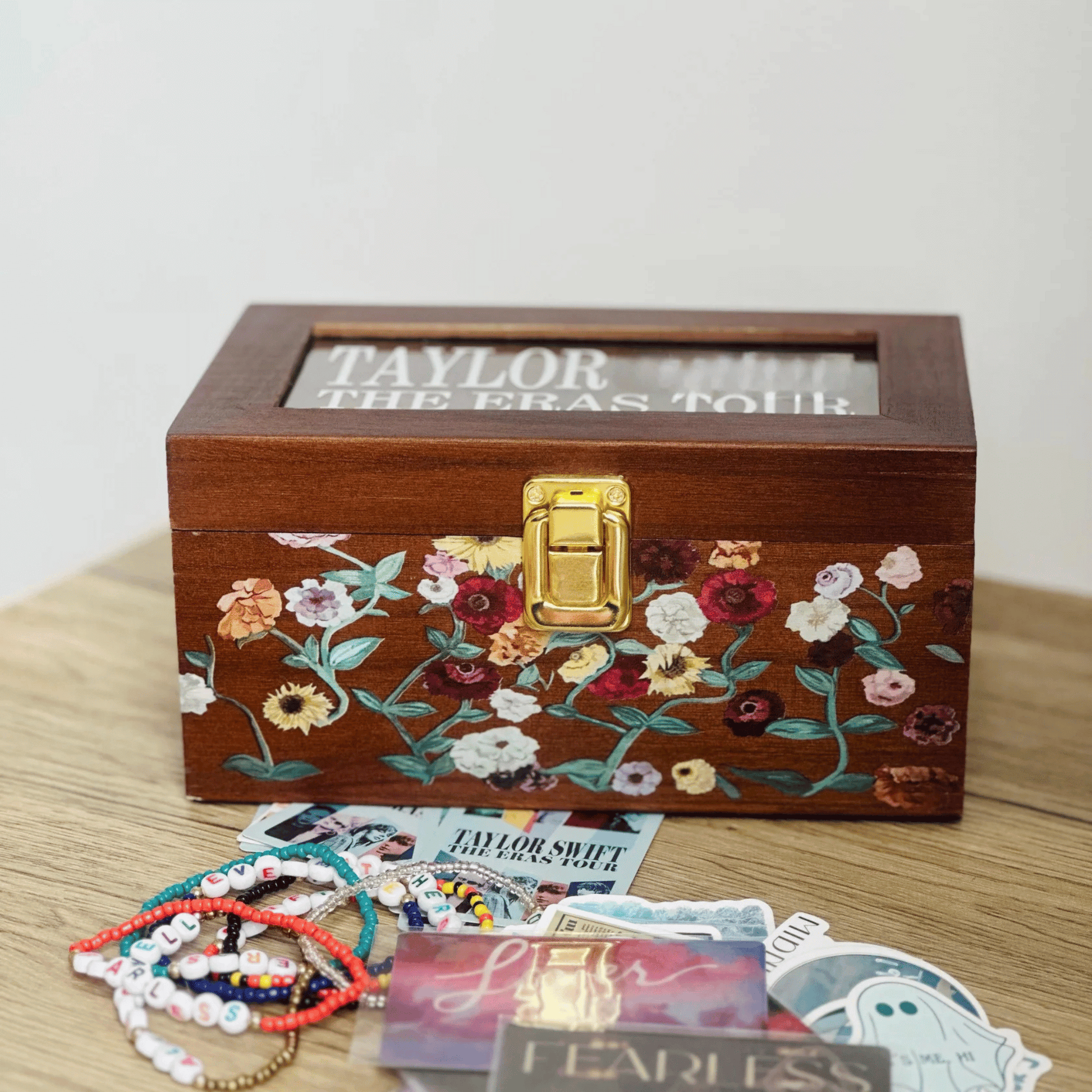 Taylor Swift Storage Wooden Box with floral design surrounded by memorabilia on a wooden surface  - Shoptown Boutique