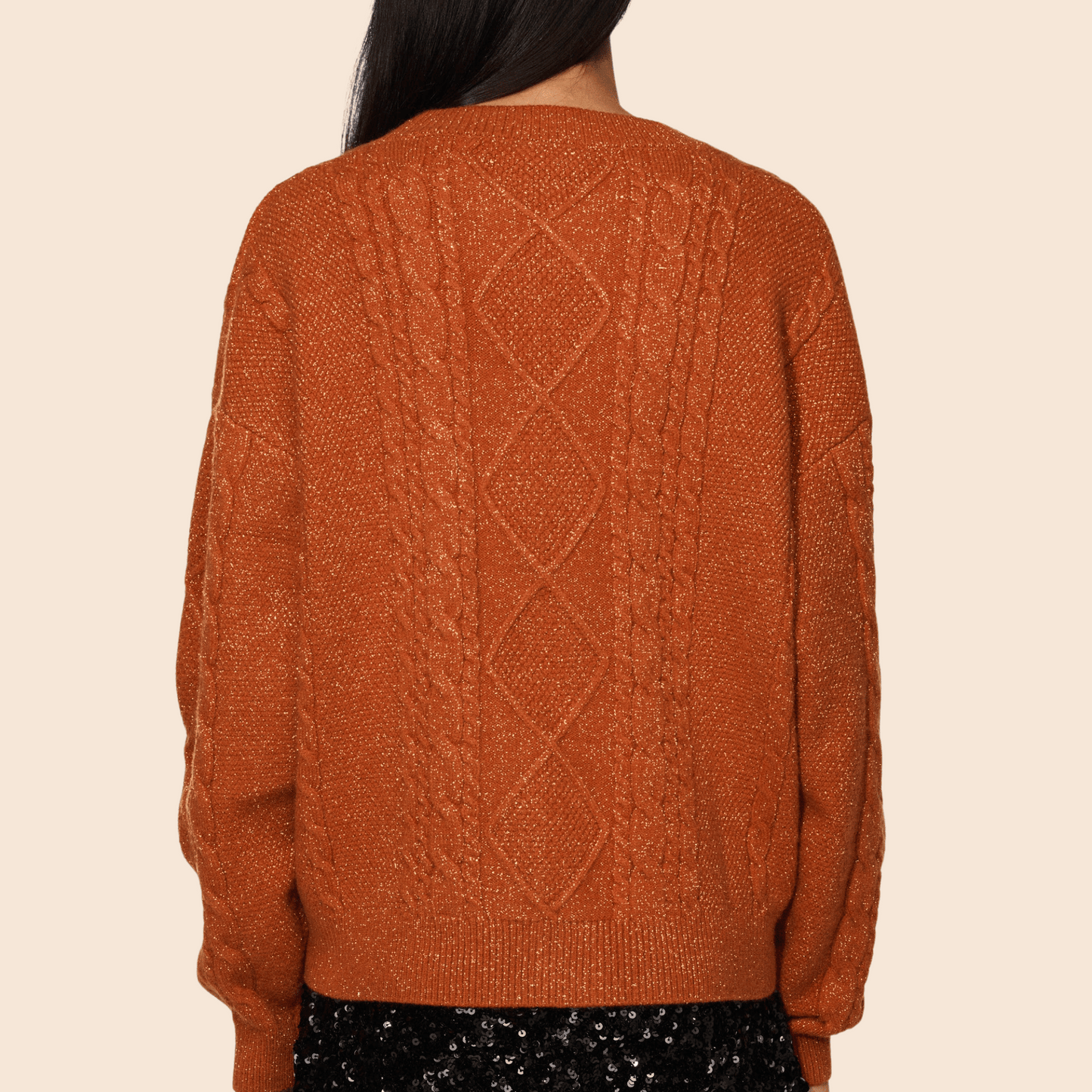 Brown knitted sweater with a geometric pattern on a beige background